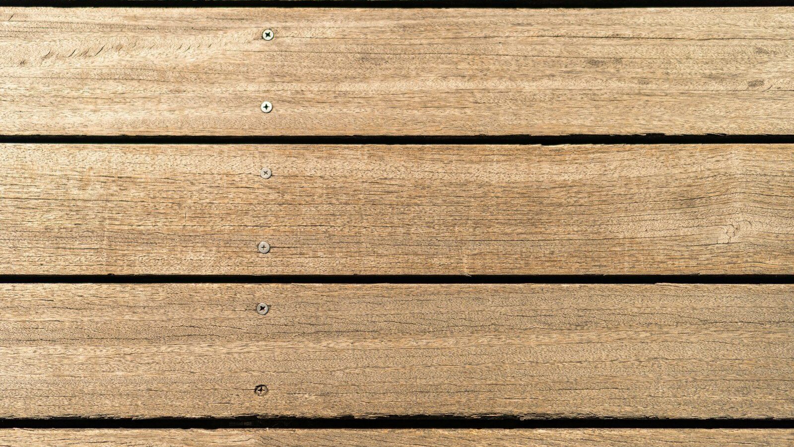 a close up of a wooden surface with nails