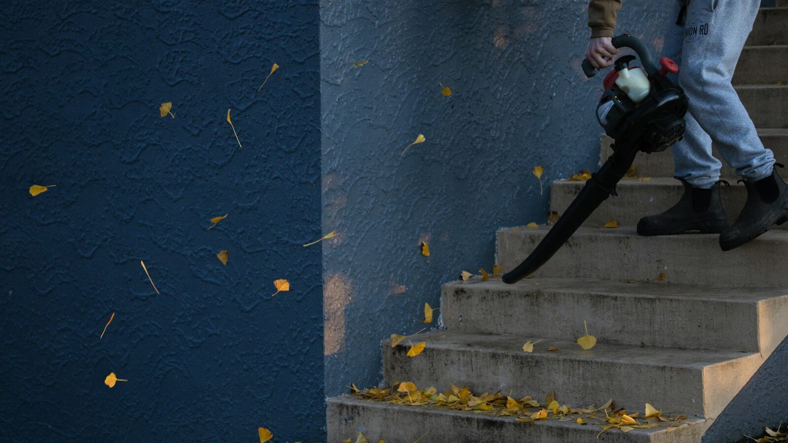 man in black jacket and pants standing on stairs