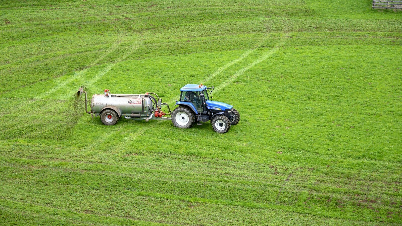 brown tractor on green grass field