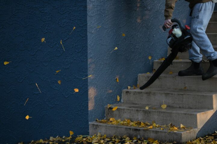 man in black jacket and pants standing on stairs