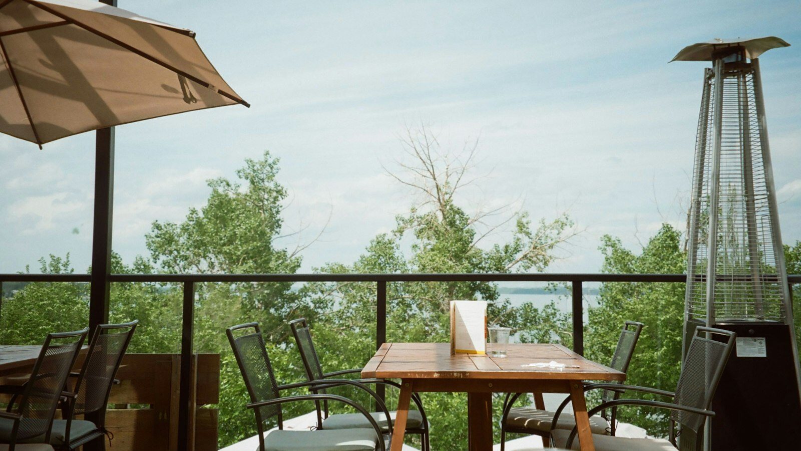 Outdoor patio seating with a view of trees and trees.