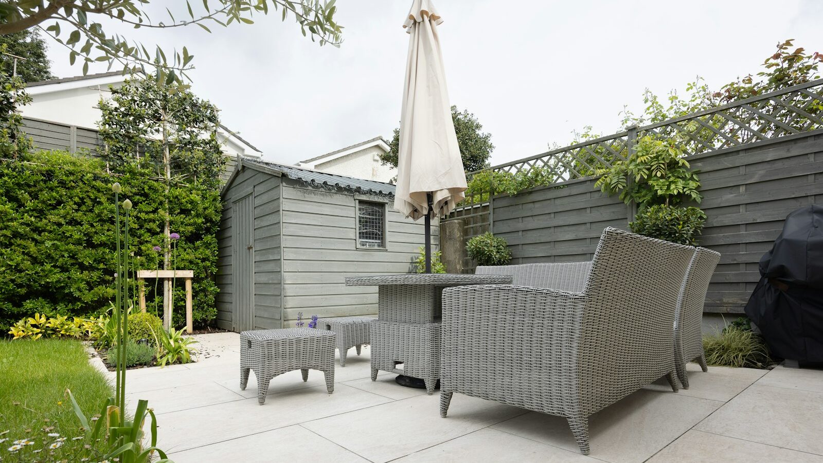 A patio with a table and chairs and an umbrella