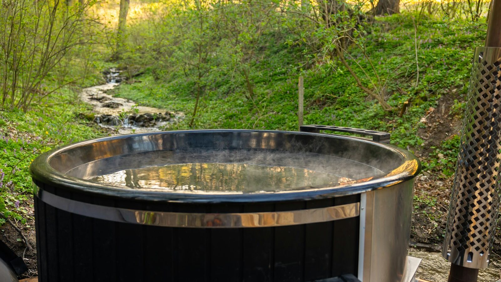 a hot tub sitting in the middle of a forest