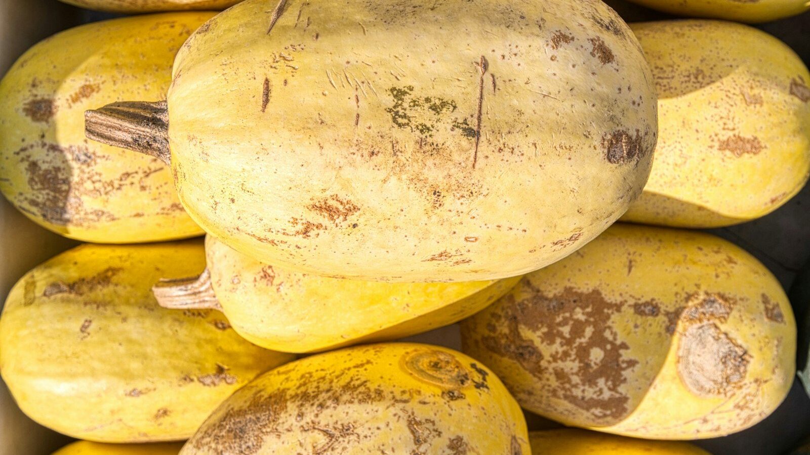 yellow oval fruit on brown wooden table