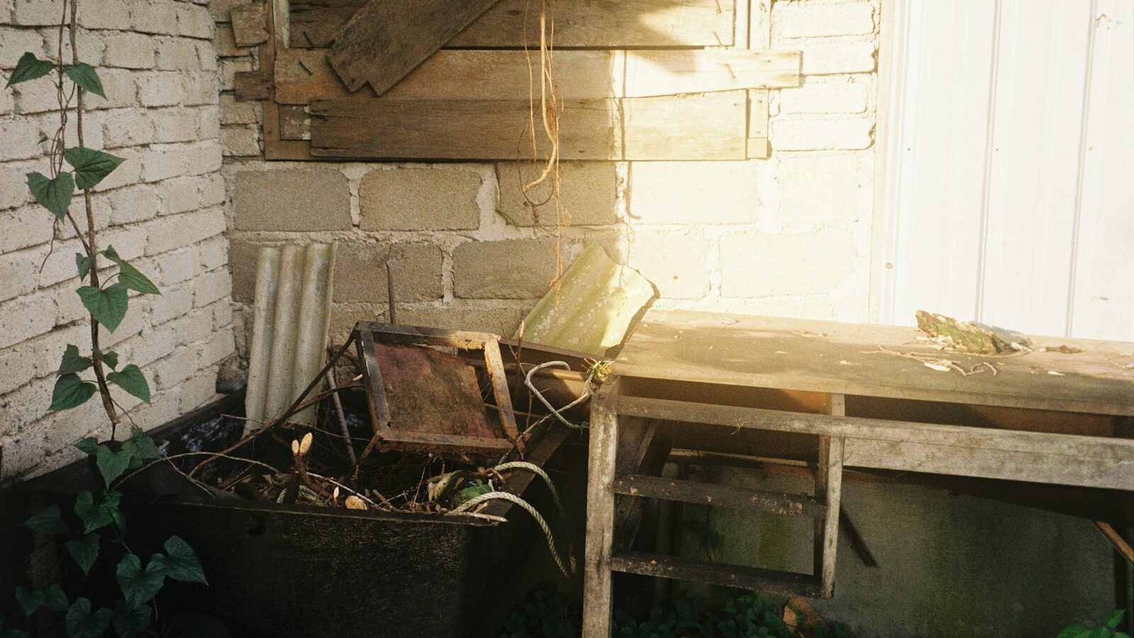 a wooden table sitting next to a brick wall
