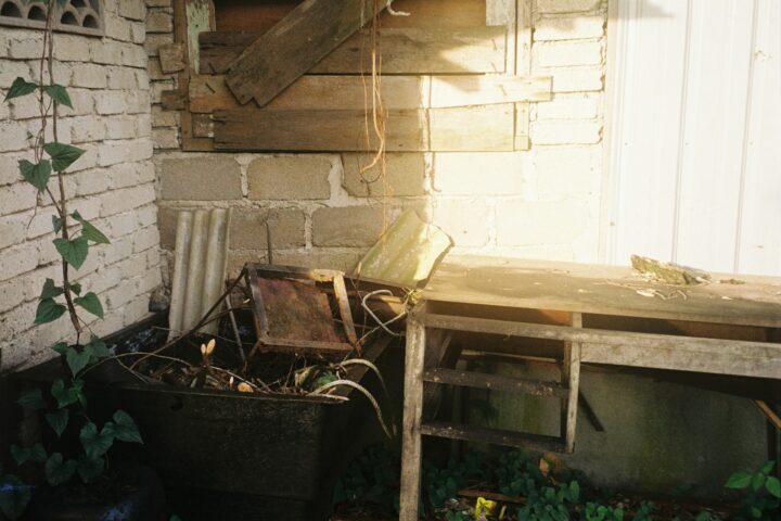 a wooden table sitting next to a brick wall