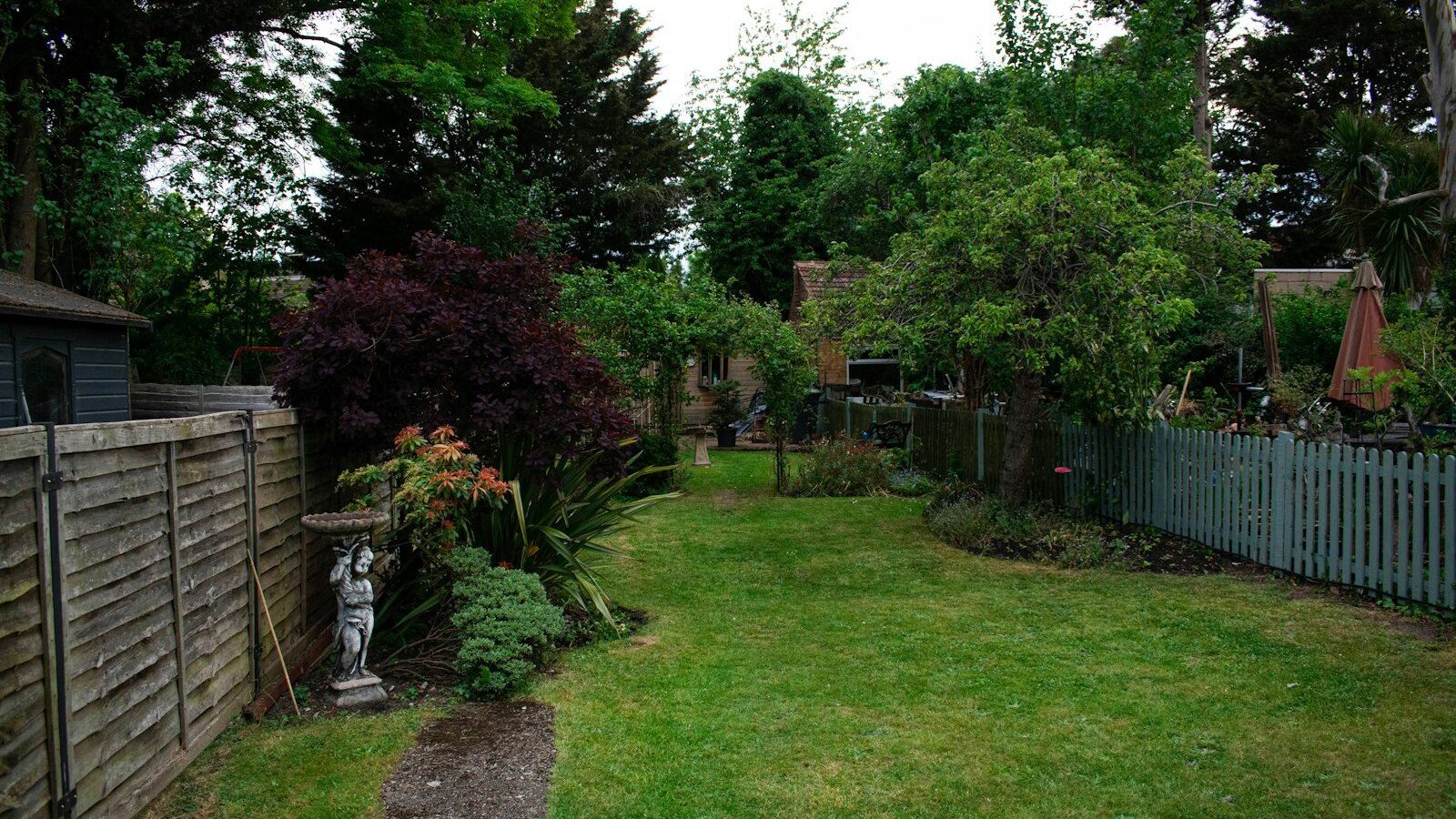 a yard with a fence and a small garden
