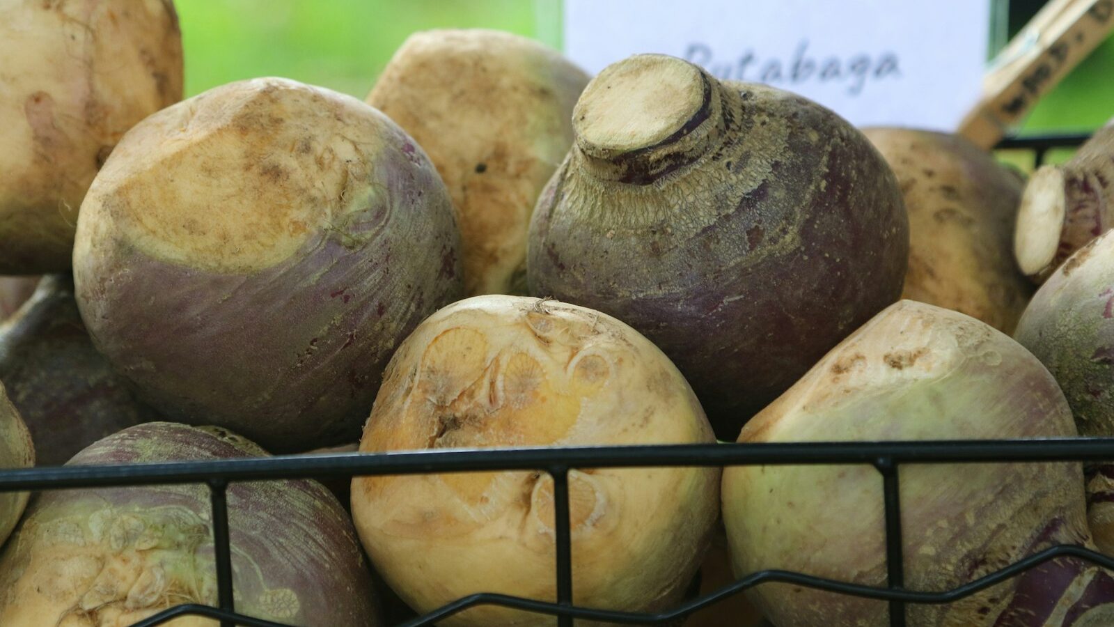 a pile of beets sitting on top of a metal basket
