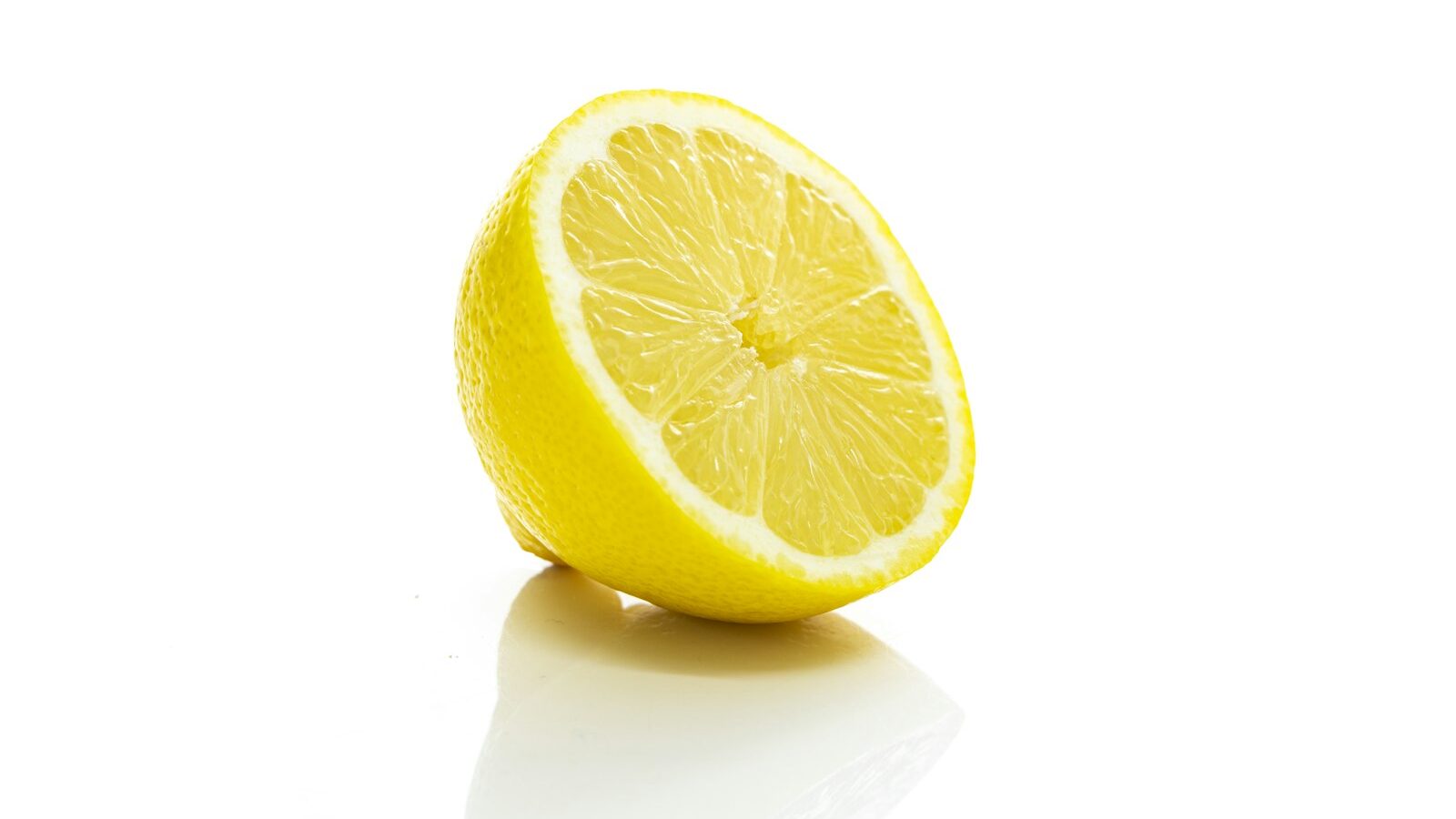 yellow lemon fruit on white surface