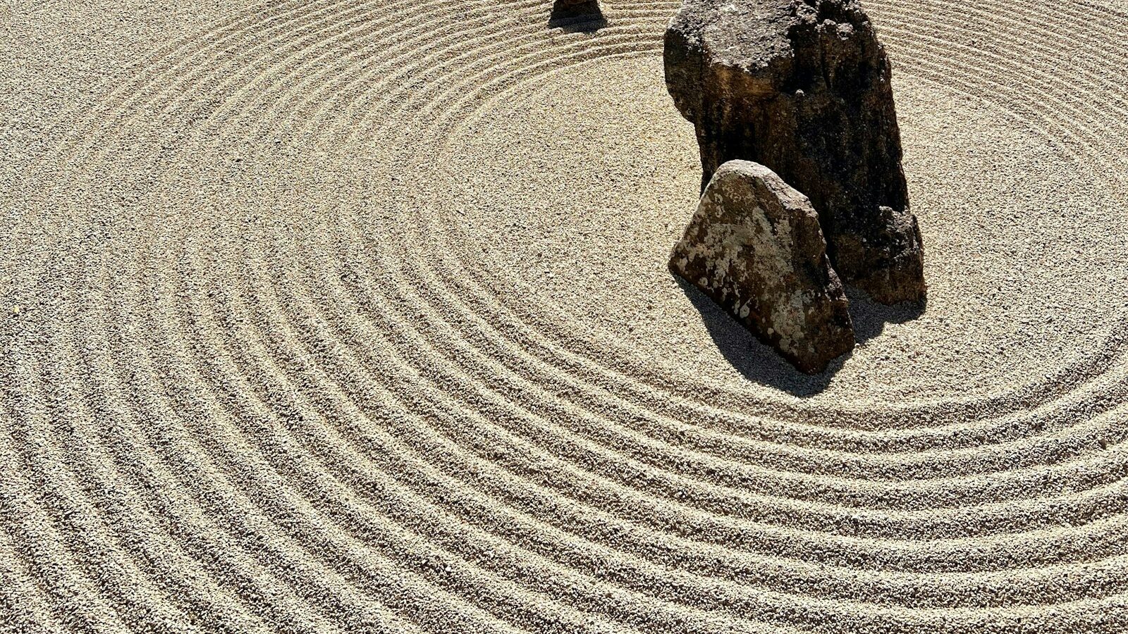 a rock sits in the middle of a circular rock garden