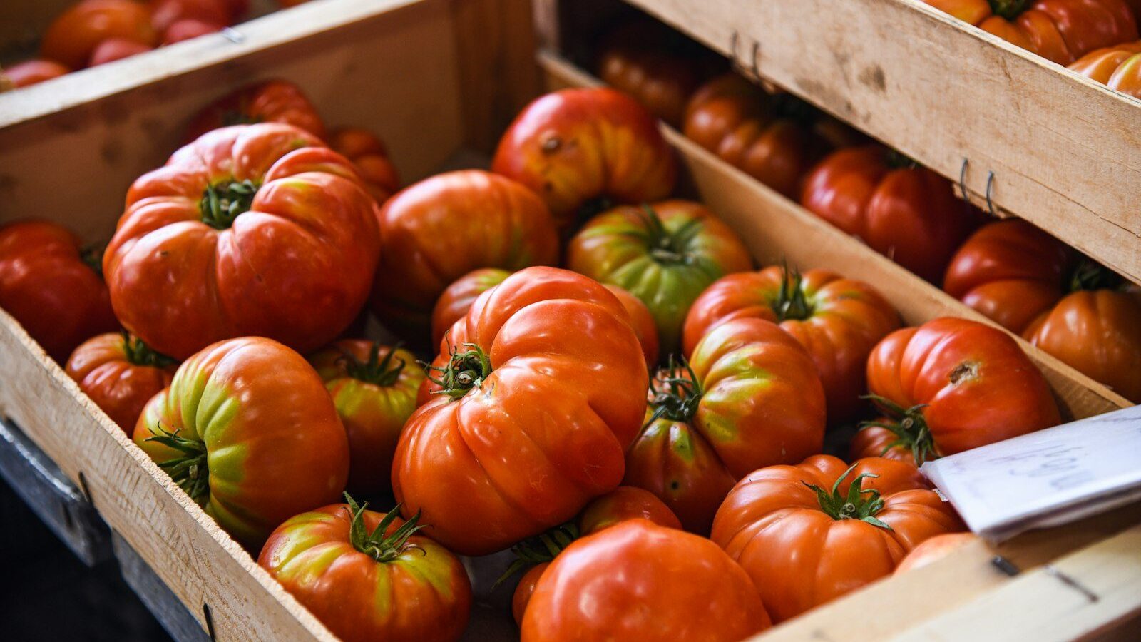 Heirloom tomatoes in wooden crates at a market