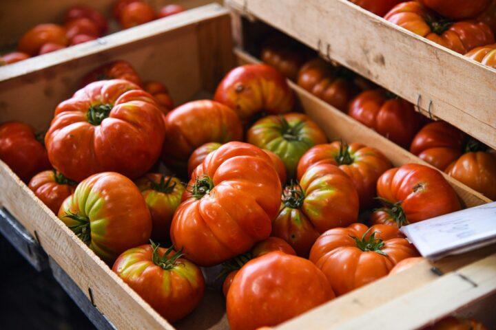Heirloom tomatoes in wooden crates at a market