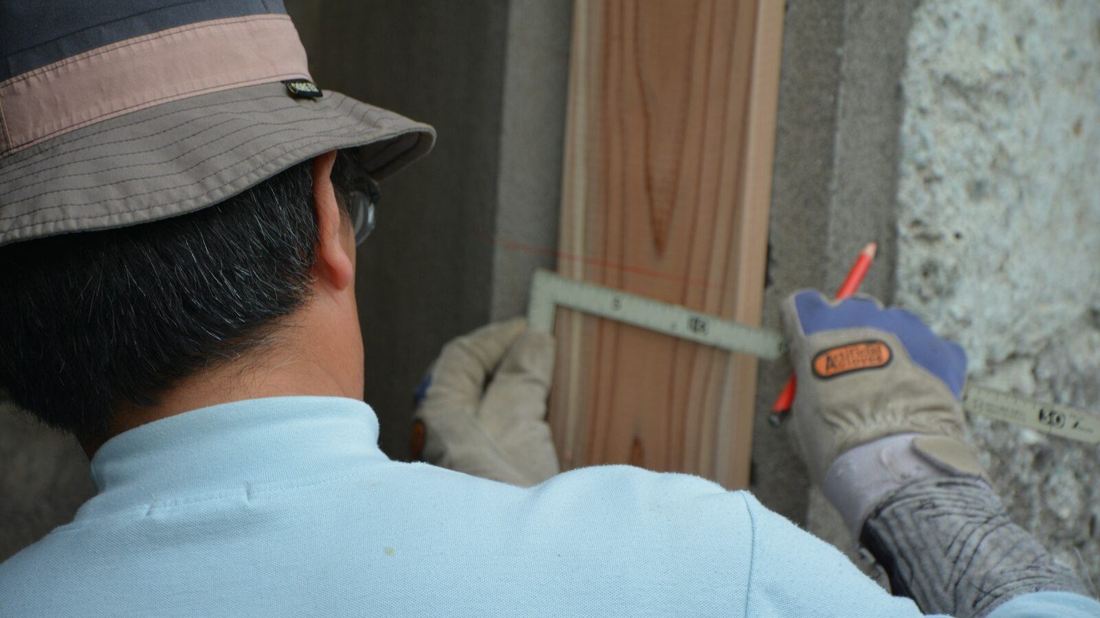 man in white shirt and black hat holding gray and red toy gun