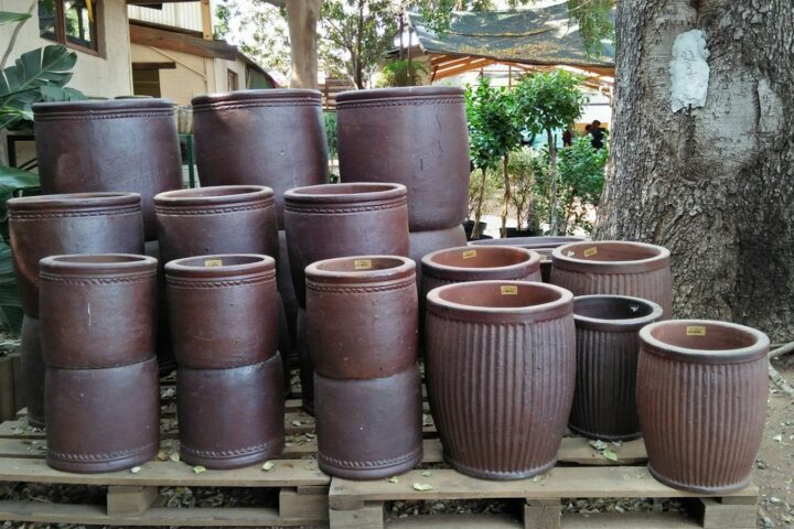 a pile of brown pots sitting on top of a wooden pallet