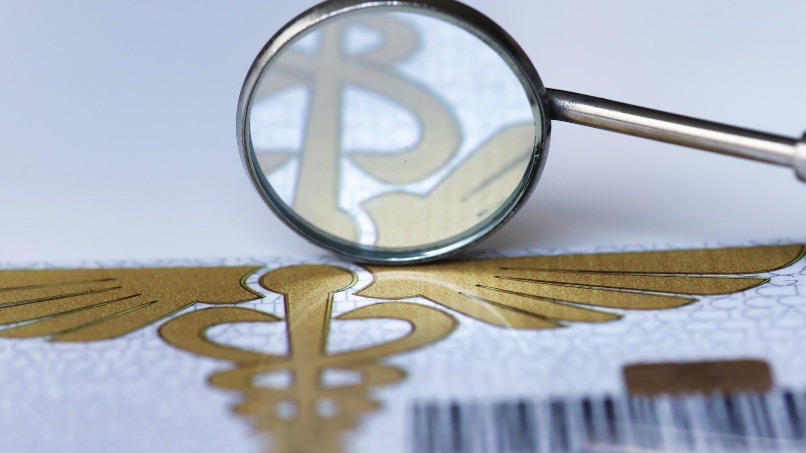 A magnifying glass over a bar code